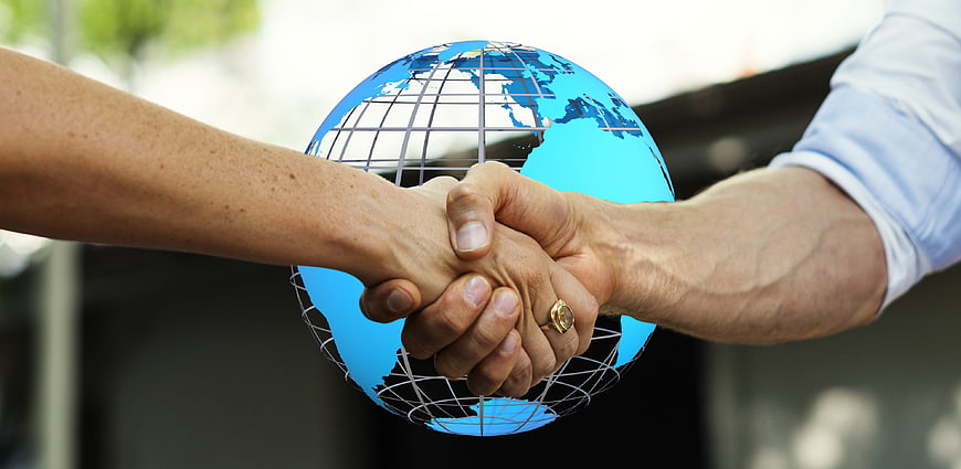Business handshake with global earth background
