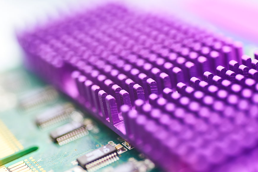Macro shot of purple computer heat sink on circuit board
