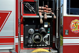 Close-up of fire truck pump panel and hose equipment