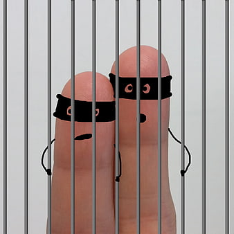Finger puppets dressed as thieves behind jail bars