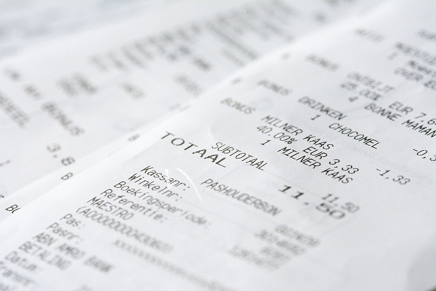 Close-up of a printed grocery receipt with itemized costs and total