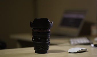 Canon Camera Lens on Desk with Laptop Background