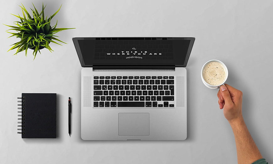 Top view workspace with laptop, coffee, and notebook