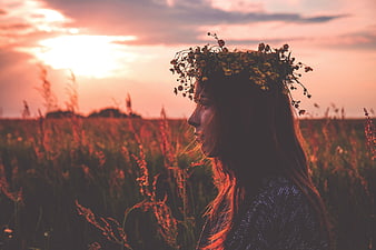 Woman with Flower Crown in Field at Sunset