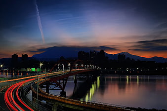 Long Exposure Night Bridge with Light Trails and Sunset Sky