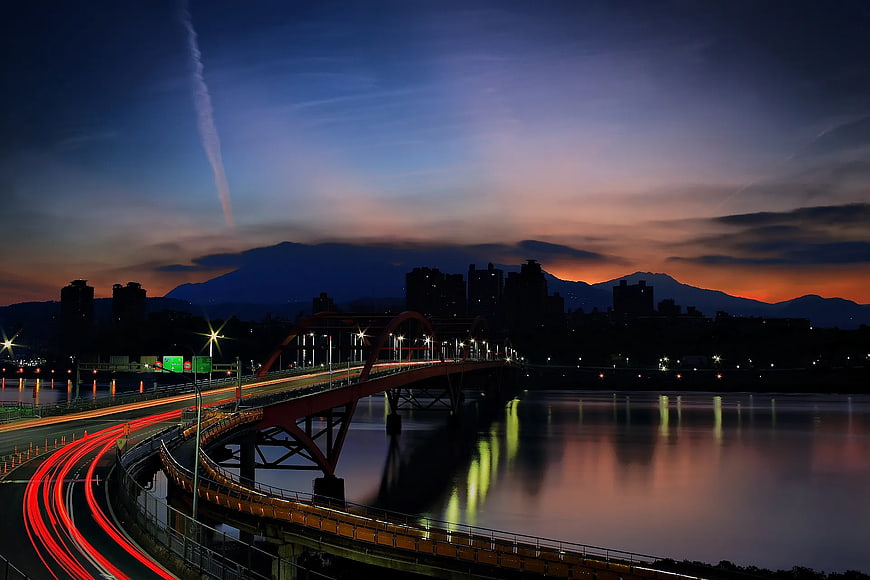 Long Exposure Night Bridge with Light Trails and Sunset Sky