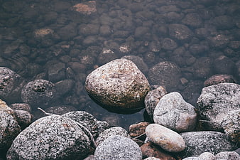 Clear shallow water with smooth river stones and rocks