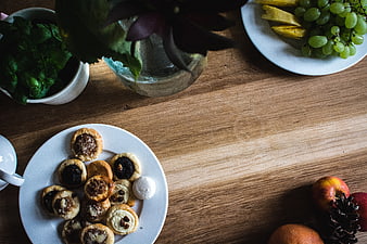 Top view of assorted pastries and fruit on a wooden table
