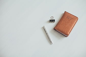 Minimalist 2017 Planner, Pen, and Binder Clip on White Desk