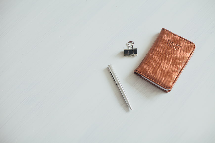 Minimalist 2017 Planner, Pen, and Binder Clip on White Desk