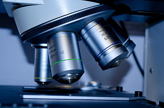 Close-up of microscope objective lenses in a laboratory