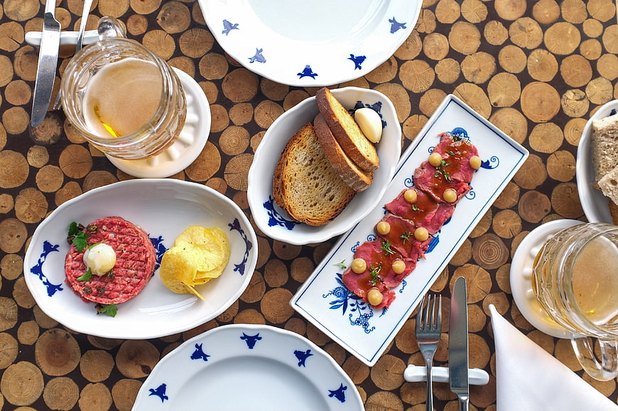 Top view of steak tartare and beef carpaccio with beer