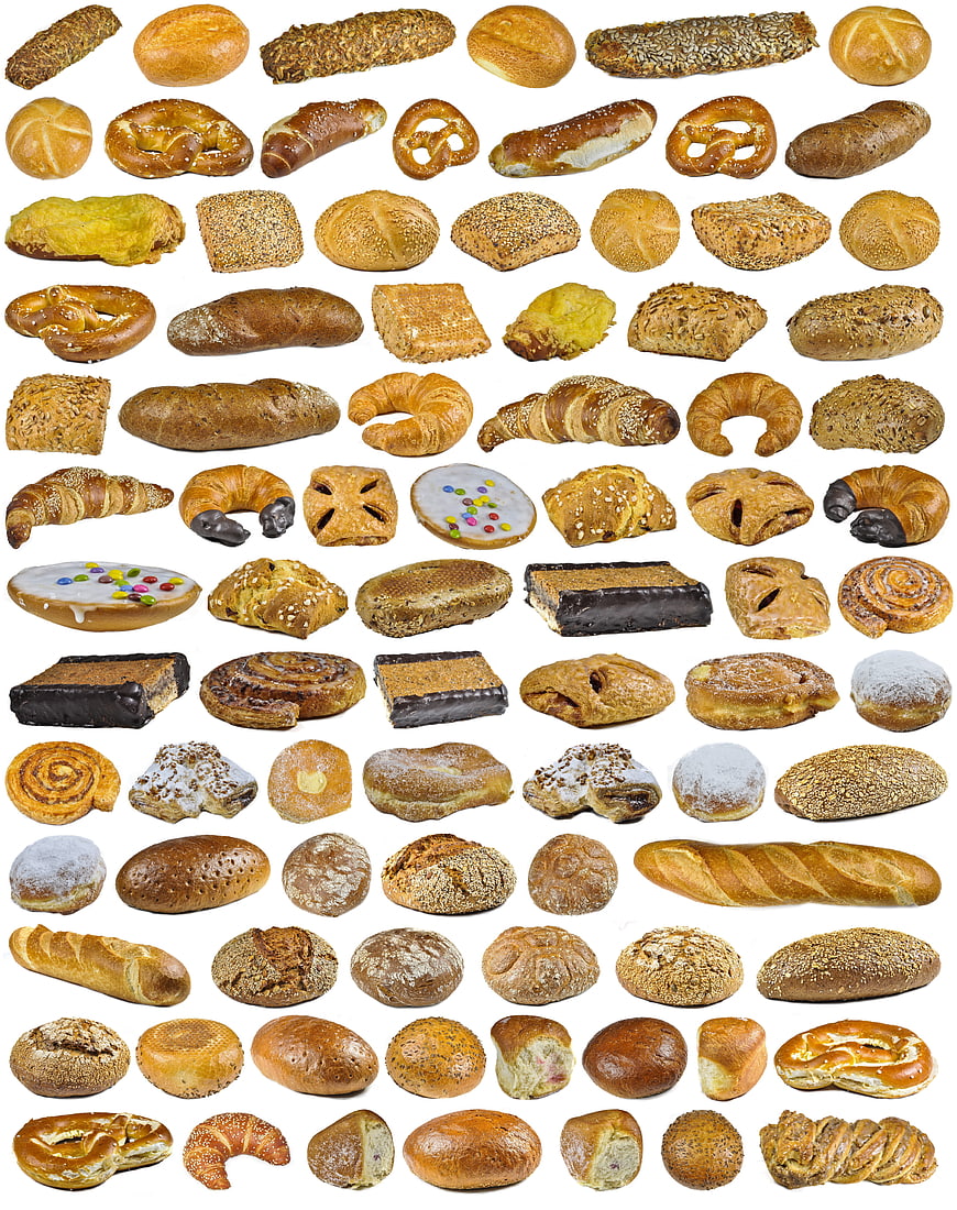 Collection of German breads, pretzels, and pastries on white background