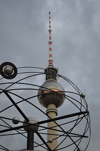 Berlin TV Tower Framed by Metal Sculpture Against Cloudy Sky
