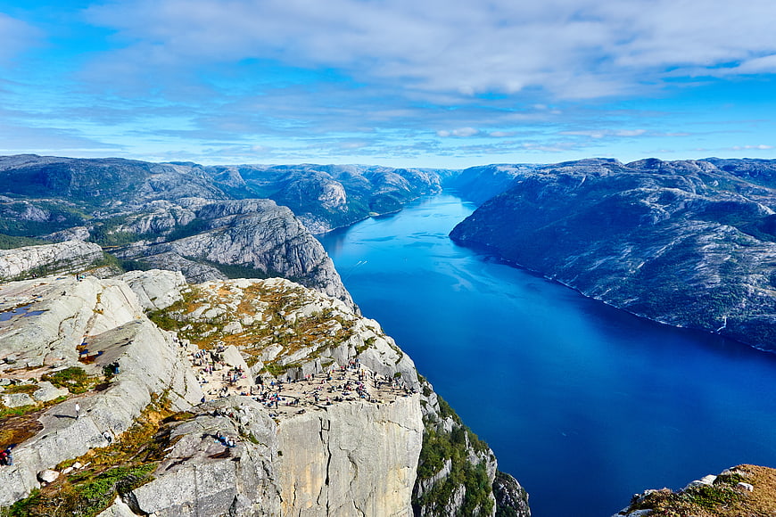 Trolltunga Rock Formation Overlooking Deep Blue Fjord in Norway