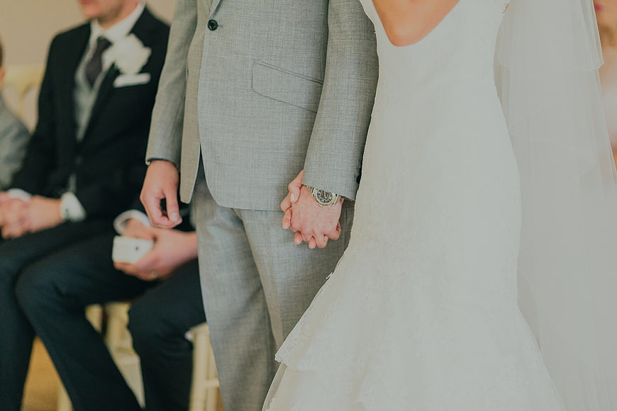Bride and Groom Holding Hands at Wedding Ceremony