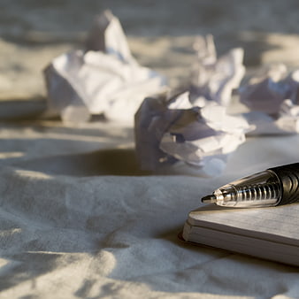 Pen on Notepad with Crumpled Paper Background