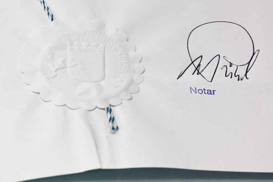 Close-up of Notarized Document with White Wax Seal and Signature