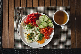 Top view of healthy paleo breakfast with eggs and vegetables
