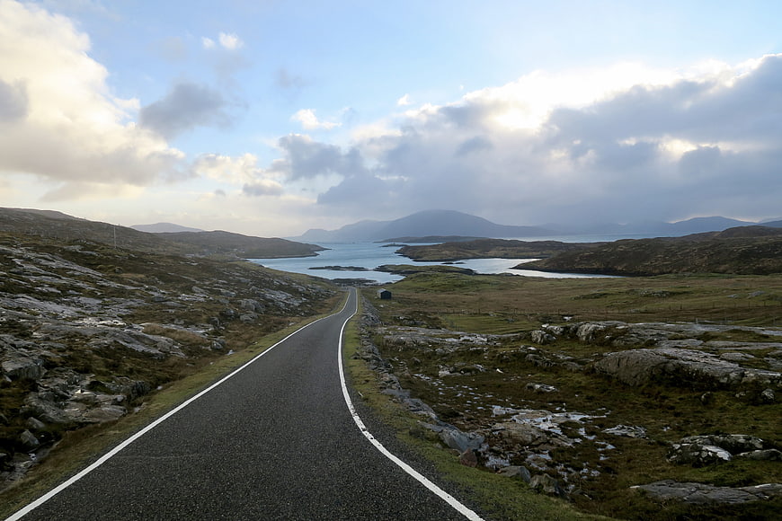 Winding coastal road leading to fjord landscape