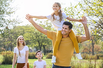 Happy Family Playing Together in a Sunny Park
