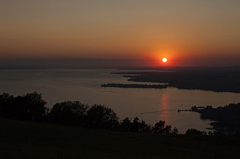 Serene Sunset Over Lake Constance with Silhouetted Islands