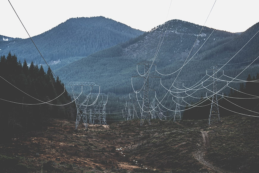 High Voltage Power Lines in Mountainous Forest Landscape