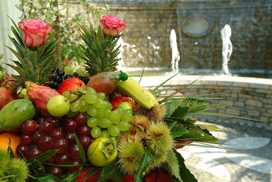 Colorful Fruit Arrangement with Pineapples, Grapes, and Roses