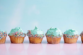 Pastel Green Cupcakes with Sprinkles on Pink Background