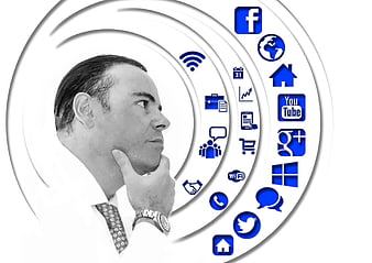 Businessman thinking with social media and technology icons