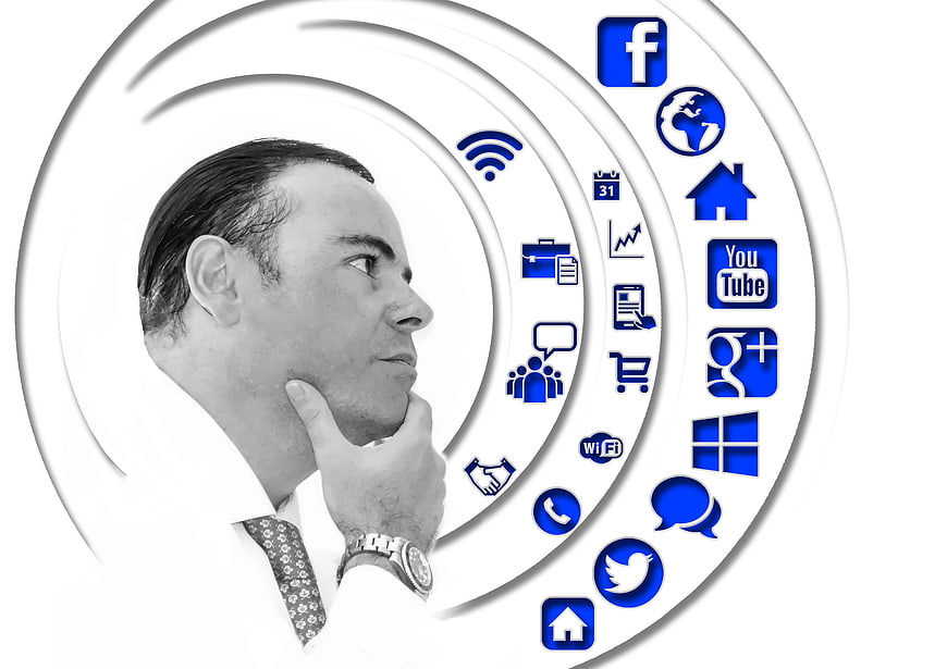 Businessman thinking with social media and technology icons