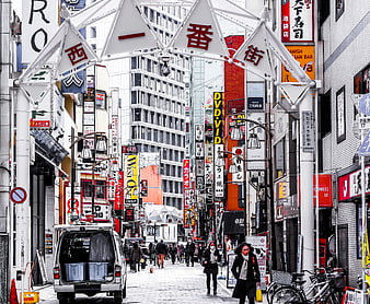 Busy Nishi-Ichibangai Street in Osaka with Pedestrians and Signs