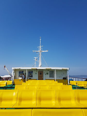 Yellow Seats on Ferry Deck Under Blue Sky