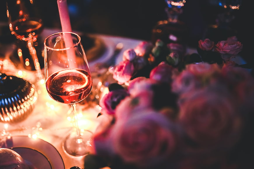 Romantic Dinner Table Setting with Wine and Flowers