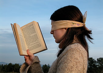 Blindfolded Woman Reading Book Outdoors