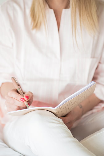 Woman Writing in Notebook with Pink Pen