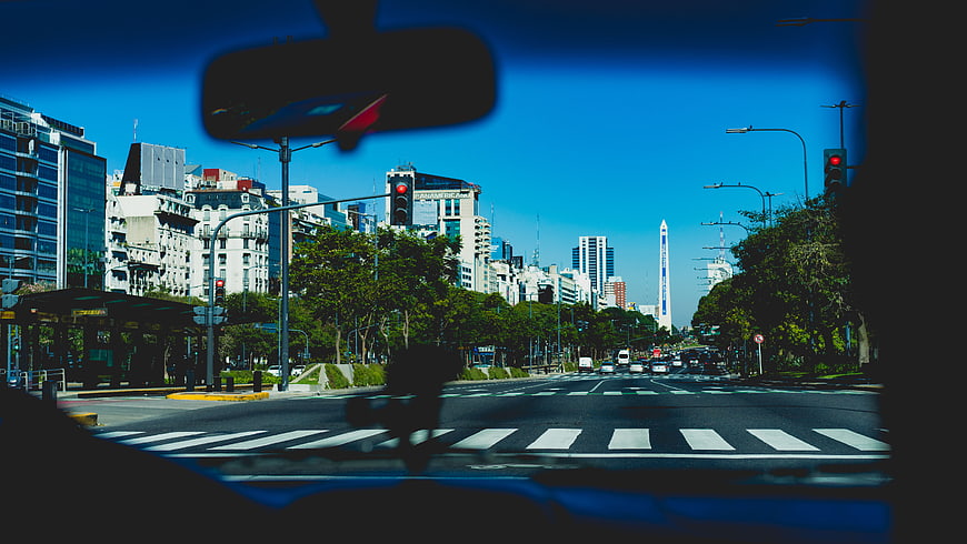 City street view from car dashboard with Obelisco in Buenos Aires