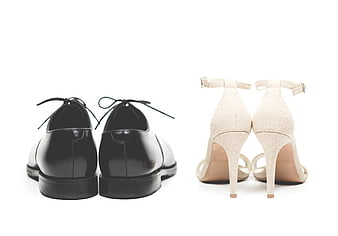 Black Oxford Shoes and Beige Heels on White Background