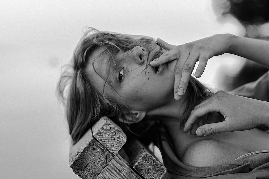 Black and white portrait of woman with hand on face
