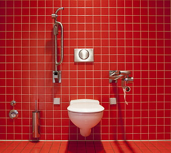 Modern accessible toilet in red tiled bathroom interior