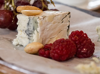 Blue cheese wedge with raspberries, grapes, and almonds