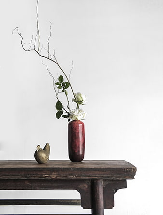 Minimalist Still Life with White Roses and Ceramic Vase on Wooden Table