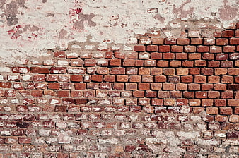 Old weathered brick wall with peeling white paint texture