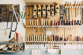 Organized woodworking tools on a wall rack