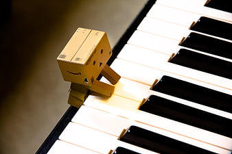 Amazon cardboard robot figure playing piano keys