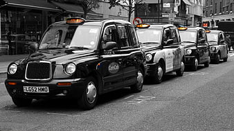 Row of black London taxis parked on a city street