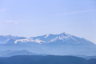 Snow-Capped Mountain Peaks with Blue Atmospheric Haze