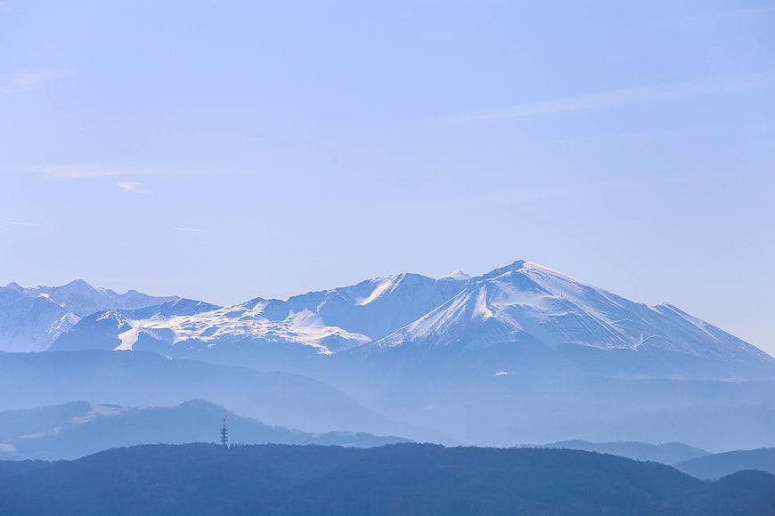 Snow-Capped Mountain Peaks with Blue Atmospheric Haze