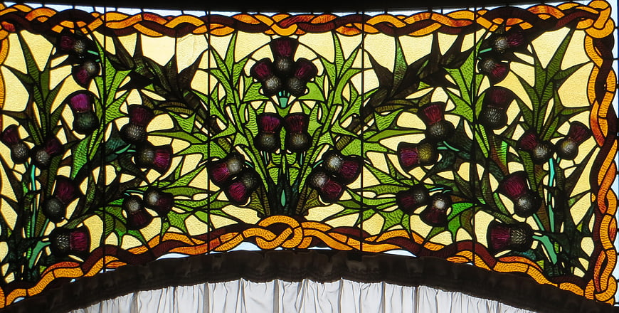 Stained glass window with thistle floral design