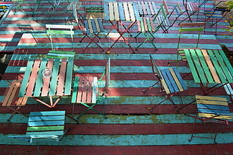 Colorful Outdoor Terrace with Wooden Tables and Chairs